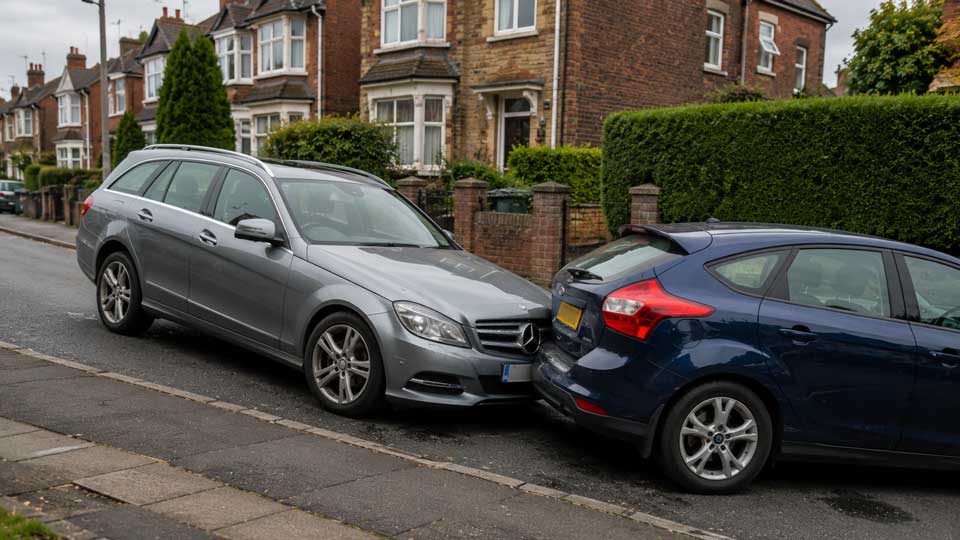 Illustration for: My car rolled away while parked and damaged another vehicle — am I insured?