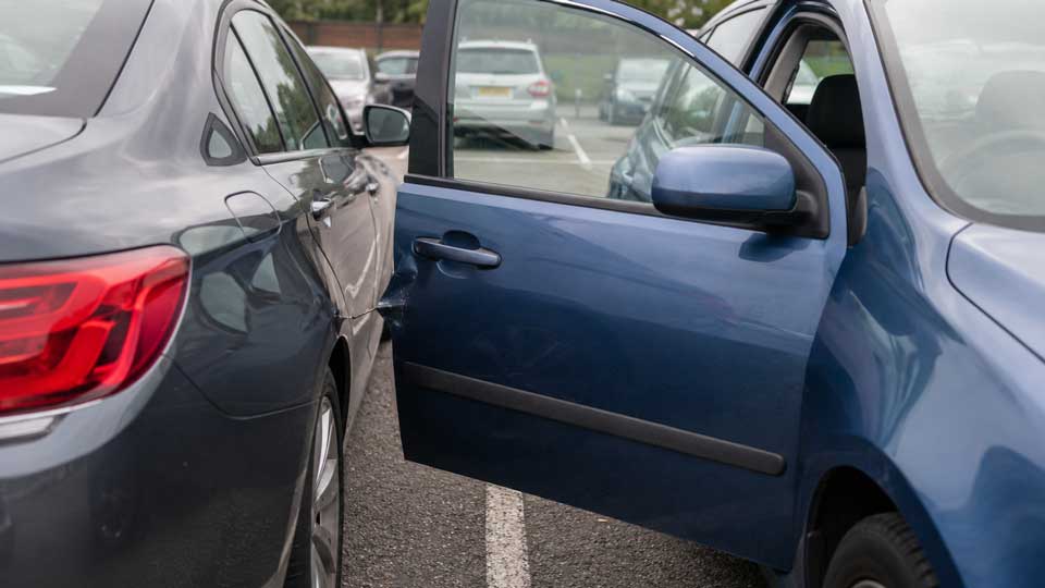 Illustration for: Someone opened their car door into mine — whose insurance should pay?